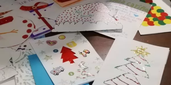 A pile of christmas postcards on a table
