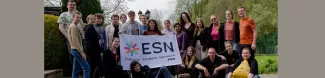 Local University students and volunteers gathered together witha flag of ESN PWr