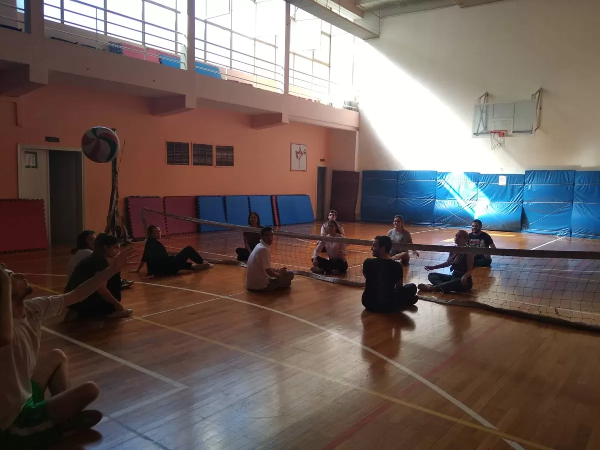 International students and ESNers playing sitting volleyball