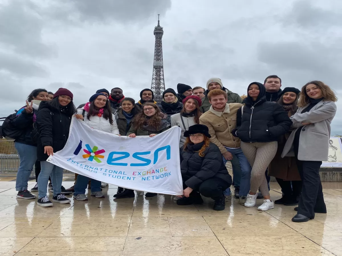 Group of people in front of the Eiffel Tower.