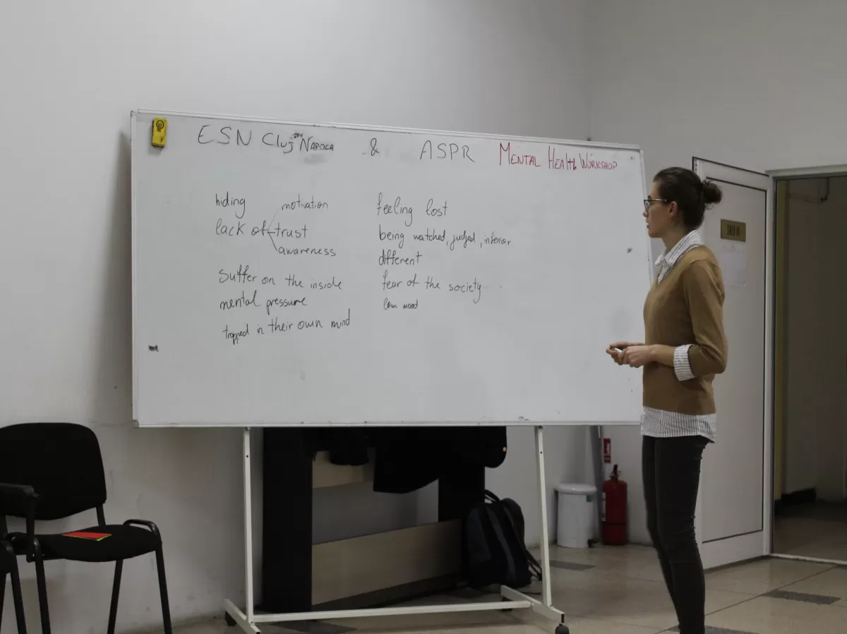 A trainer writing on a white board.