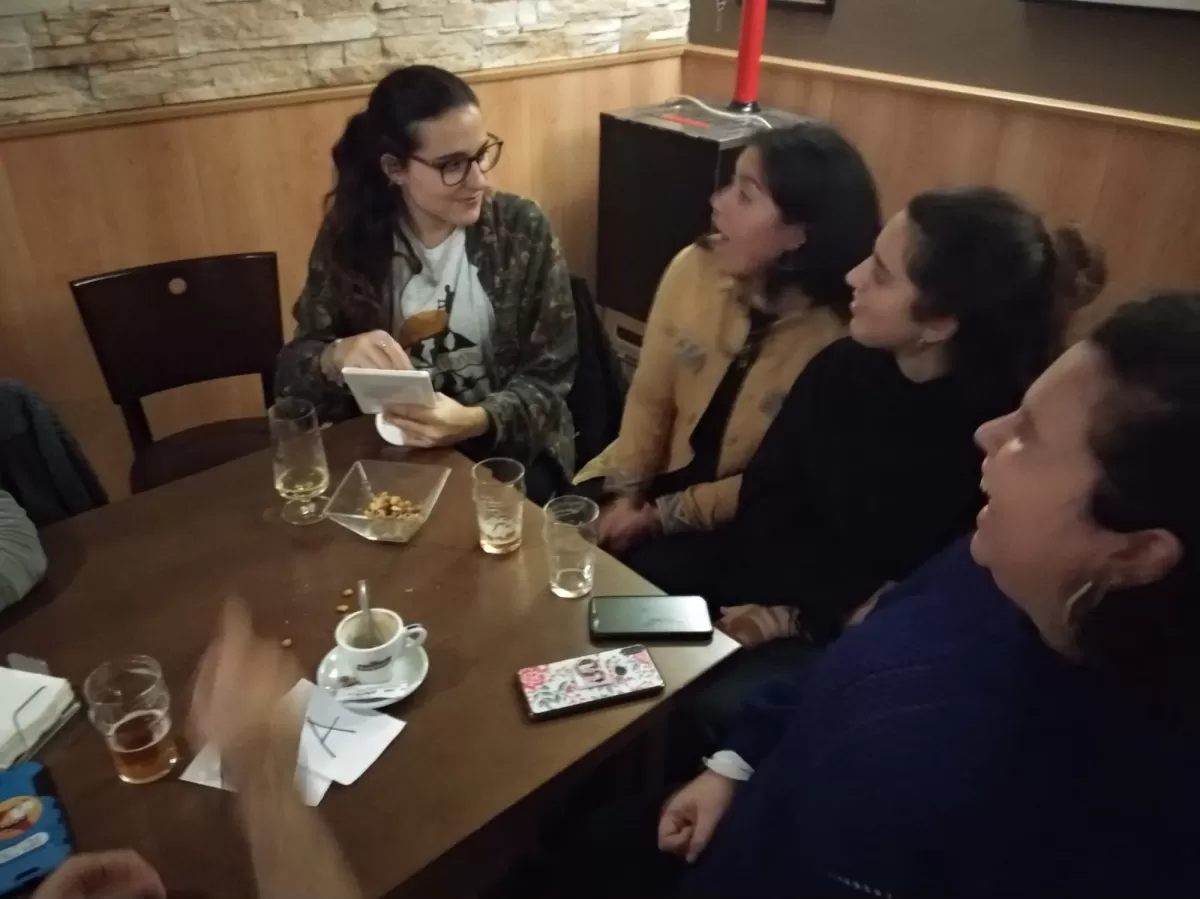 Four people talk at a bar