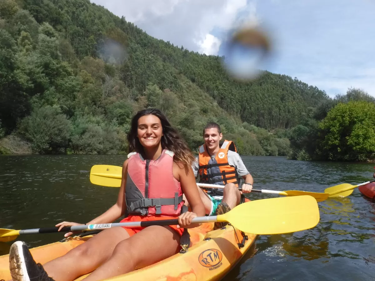 Two ESN volunteers kayaking and smiling for the camera.