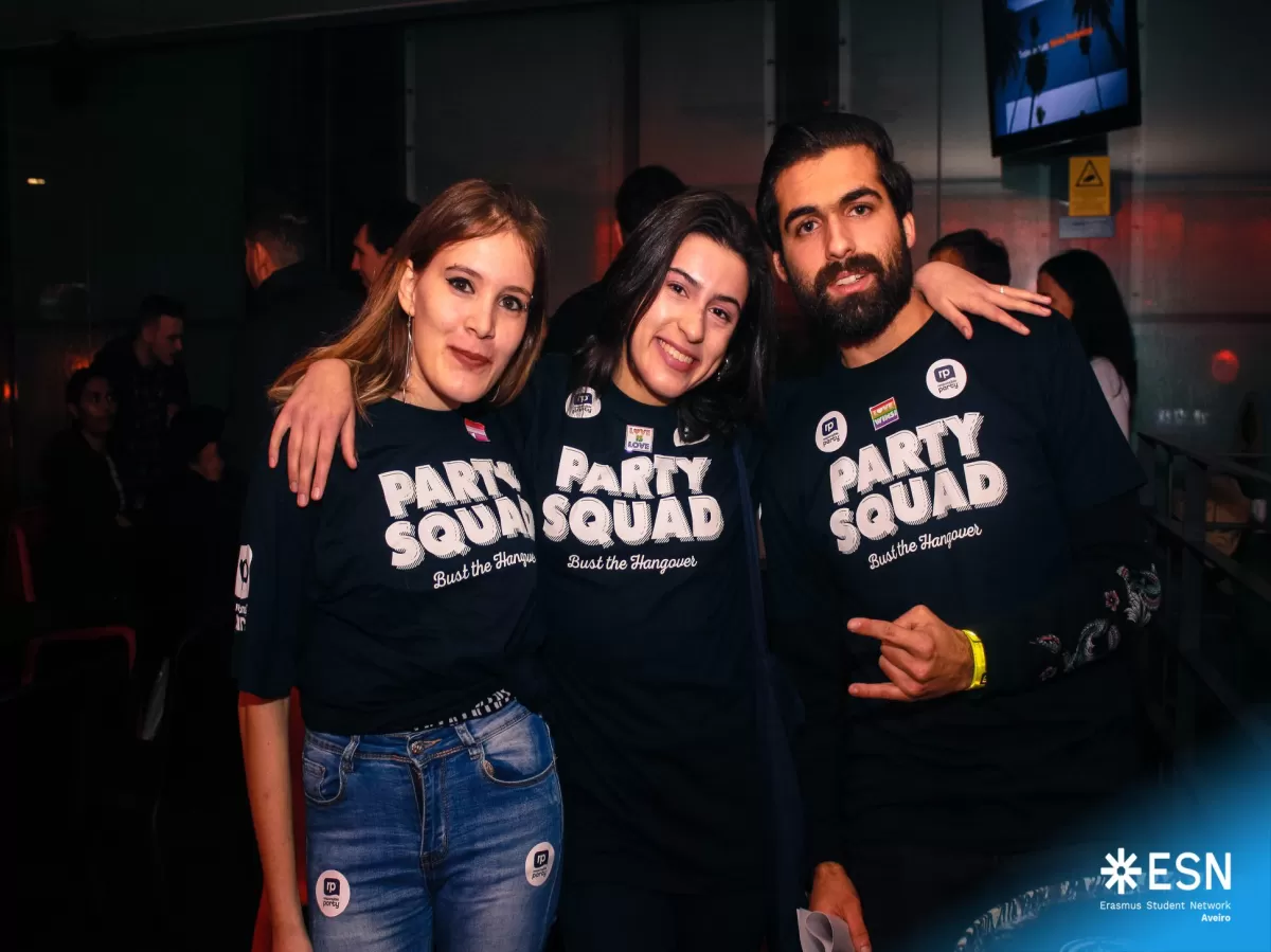 Three ESN volunteers wearing "Party Squad" t-shirts and smiling at the camera.