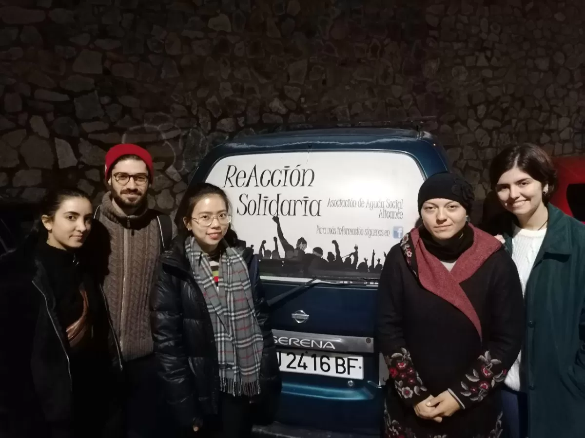 Group of students standing in front of the van that will be used for the delivery