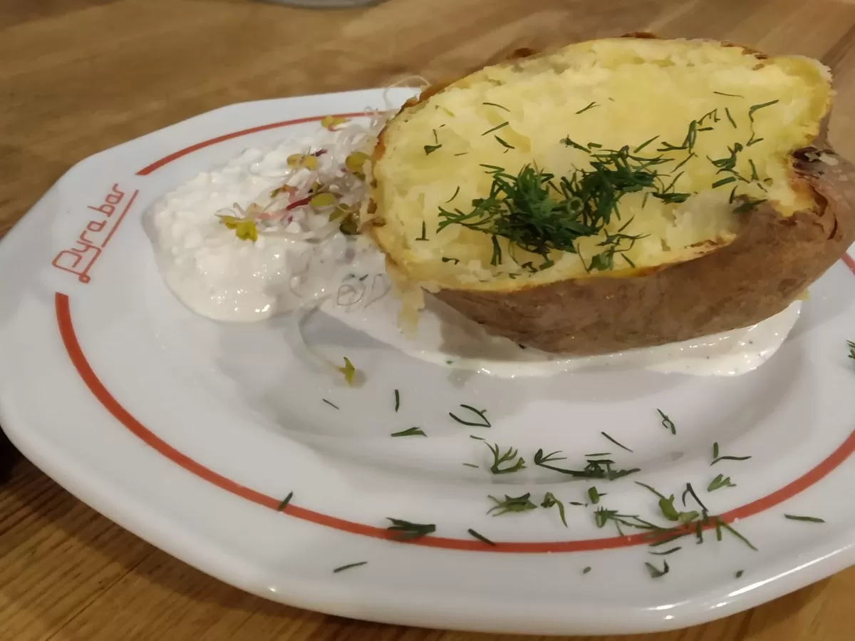 A plate with baked potato and cottage cheese - "pyra z gzikiem"