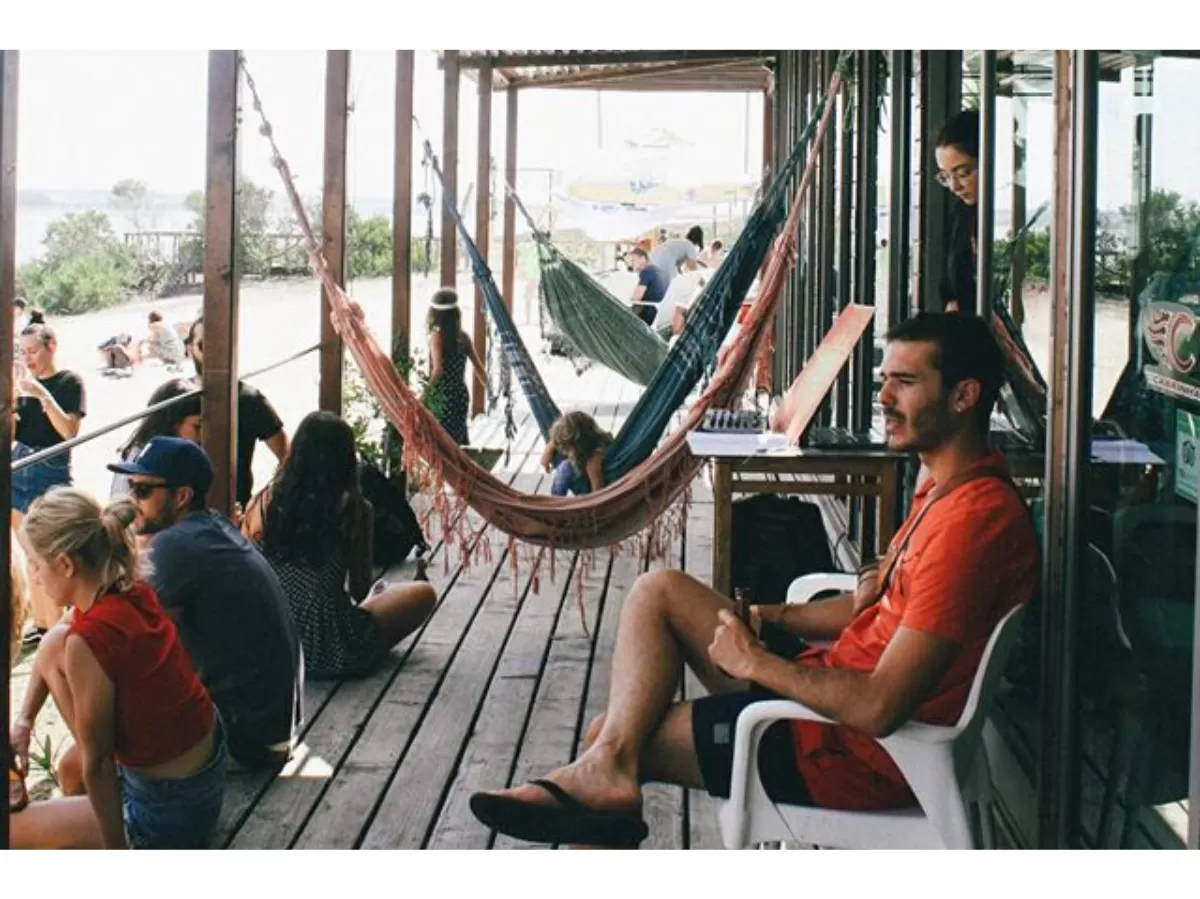 The Erasmus are on a hammock or just sitting, relaxing.