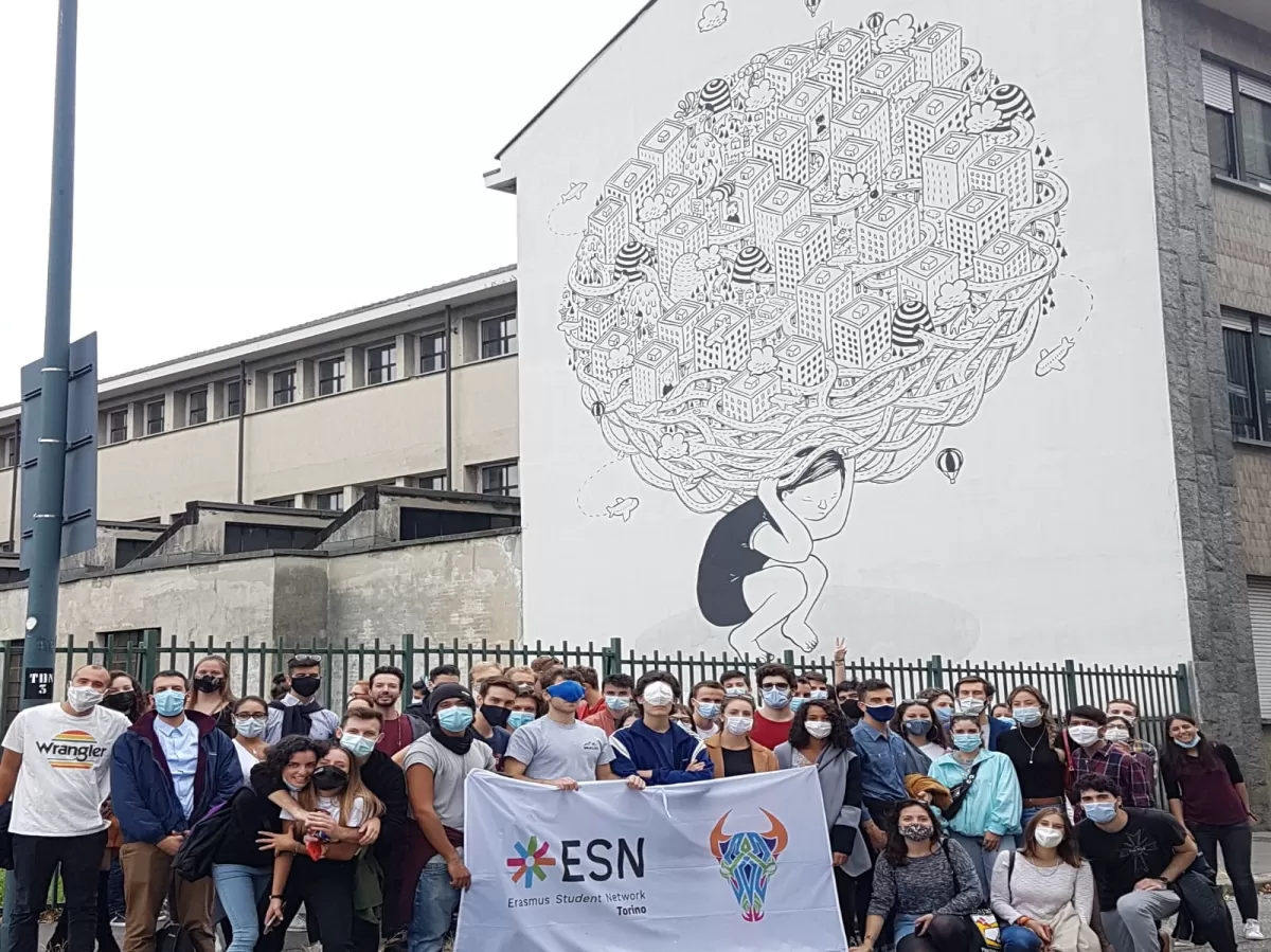 Erasmus students in front of Millo's street art work