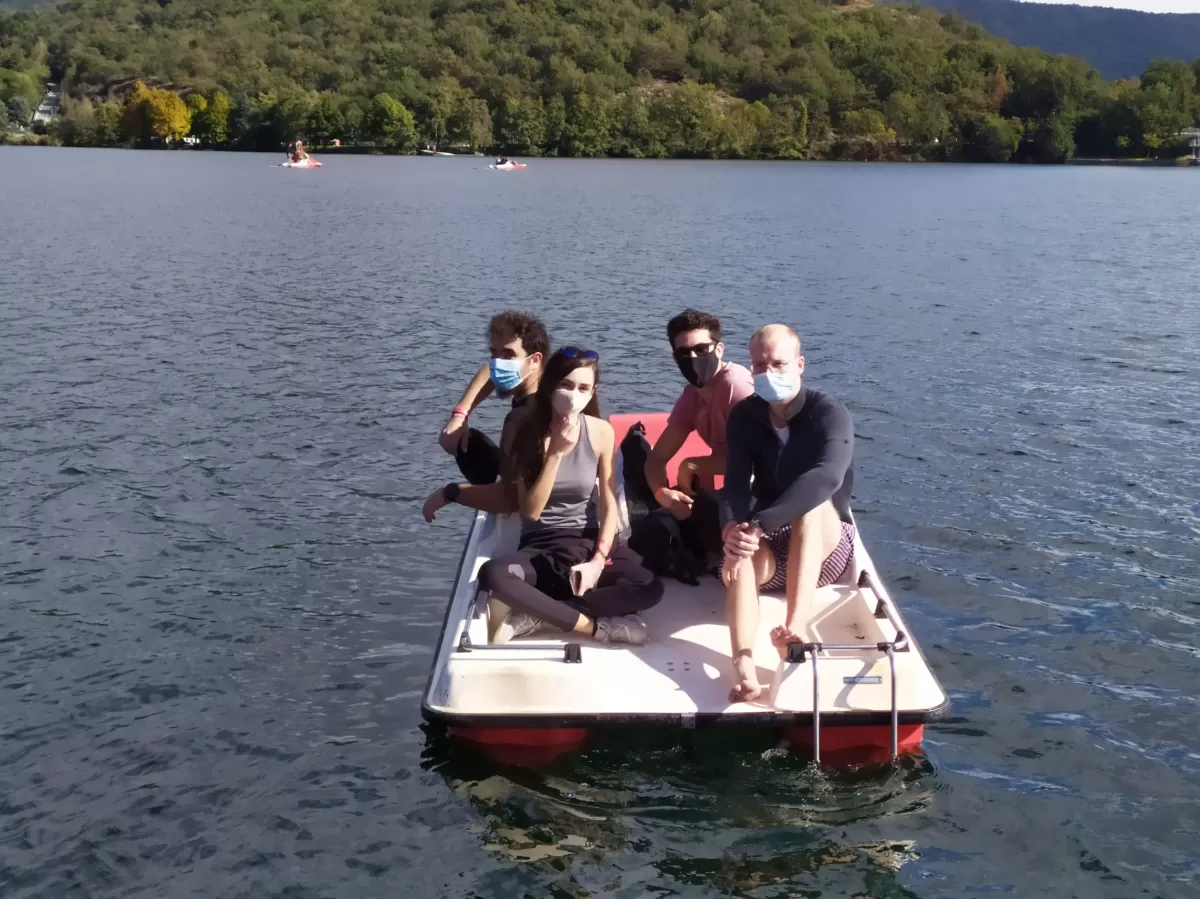 Group of international students going with paddle boat