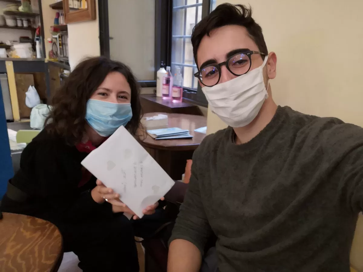 two people smiling with the mask on