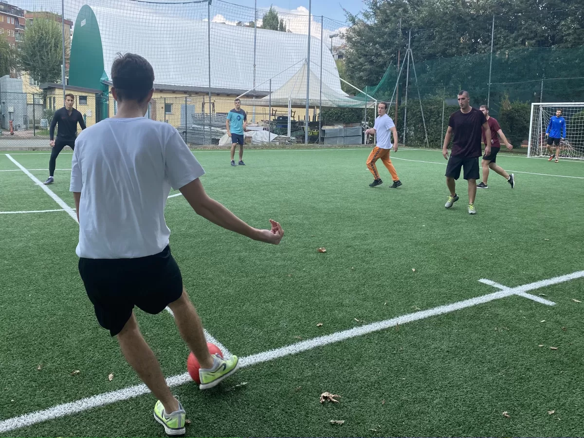 Group of international students playing football
