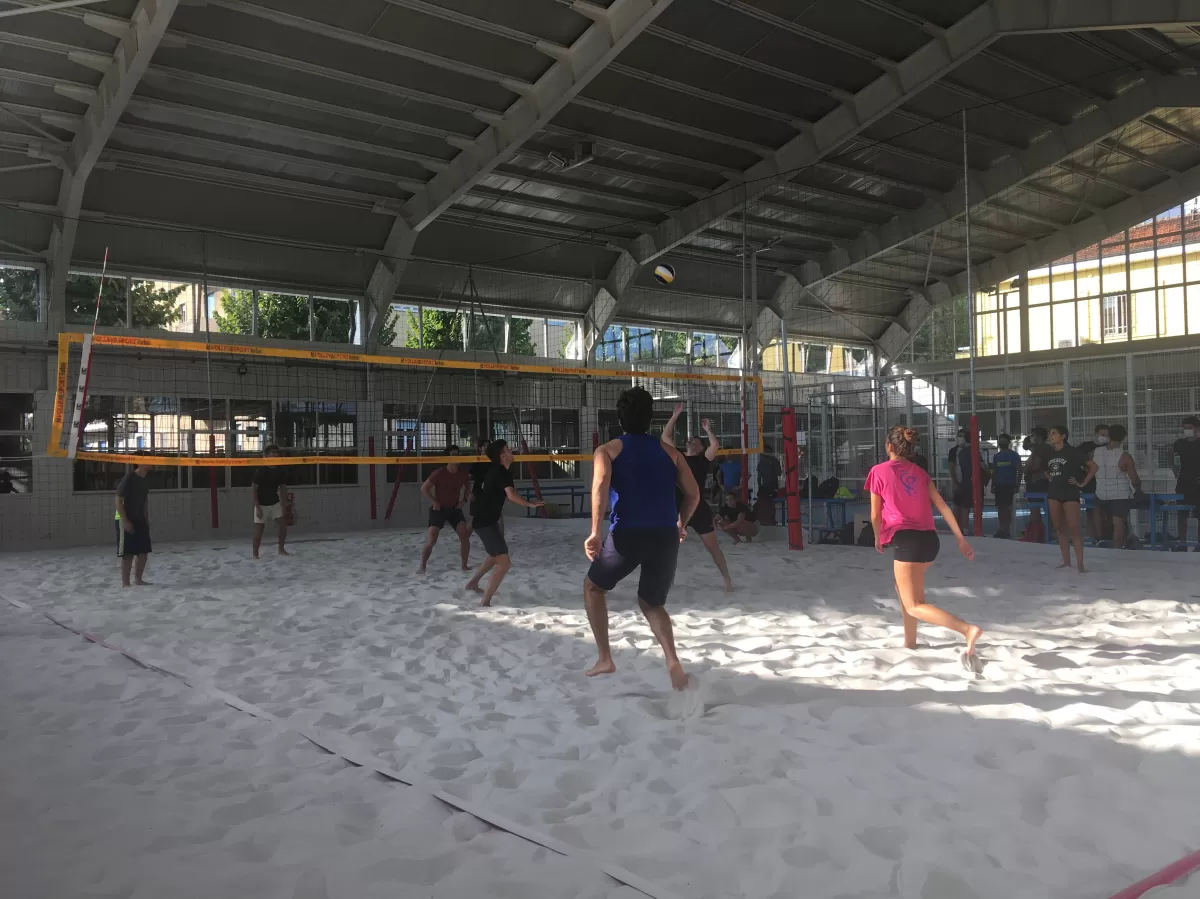 Group of international students playing beach volley
