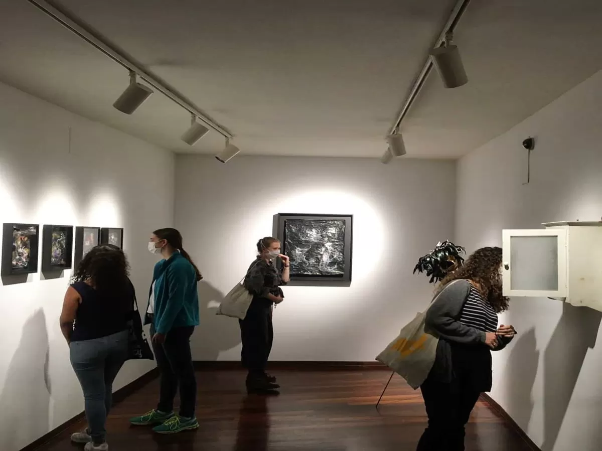 Erasmus students looking at some work of arts