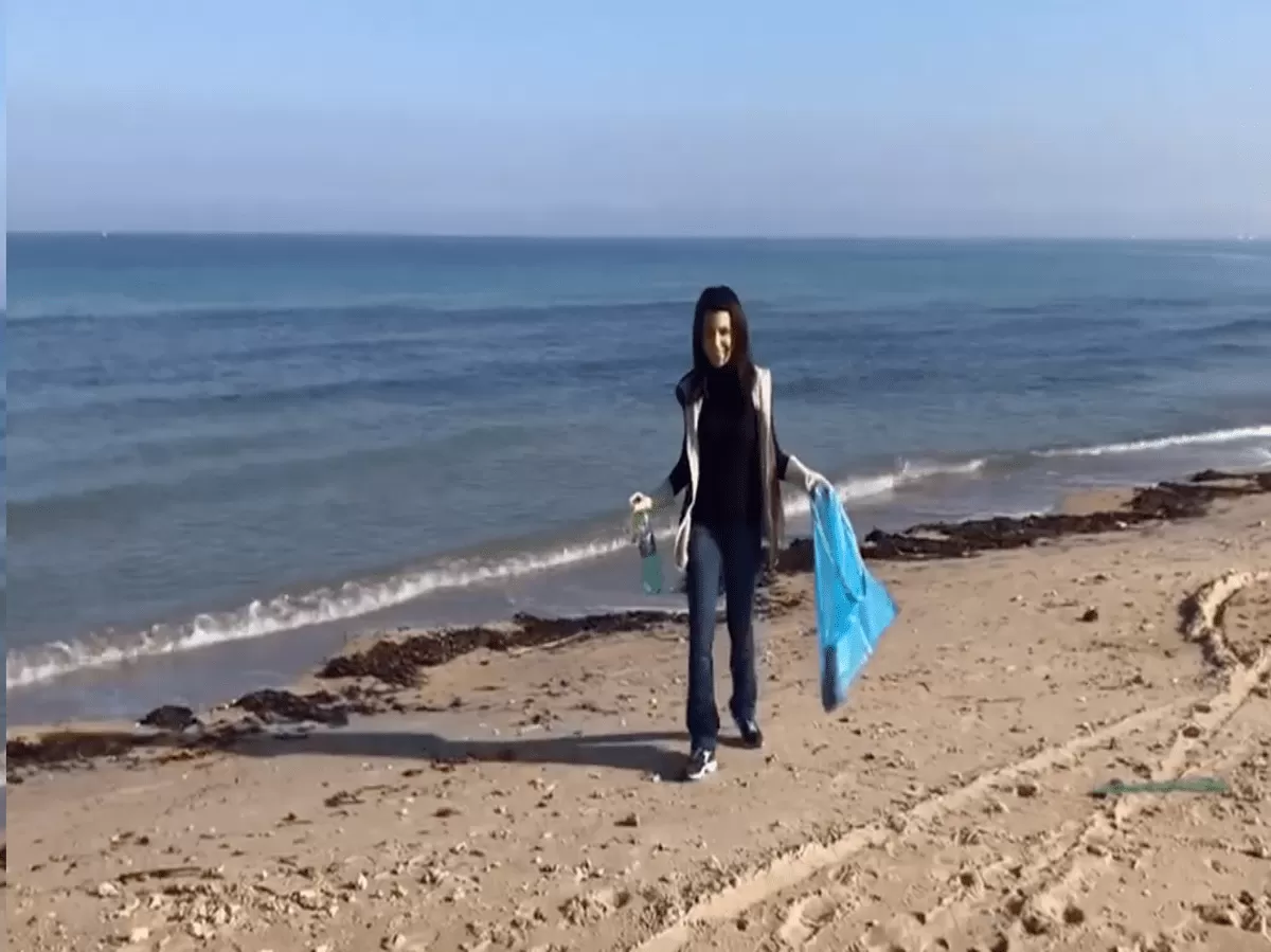 A student cleaning the beach