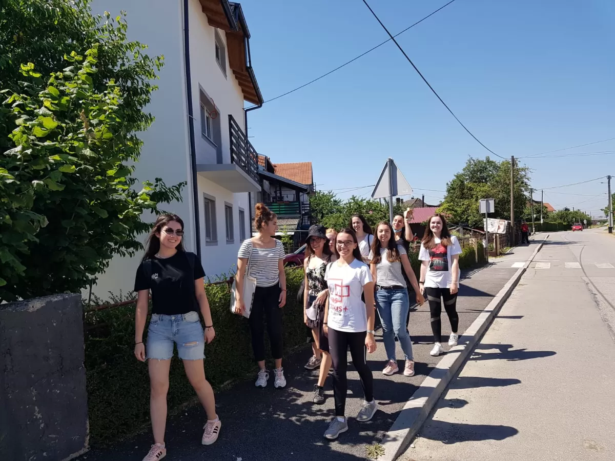 A group of girls walking trough a local town.