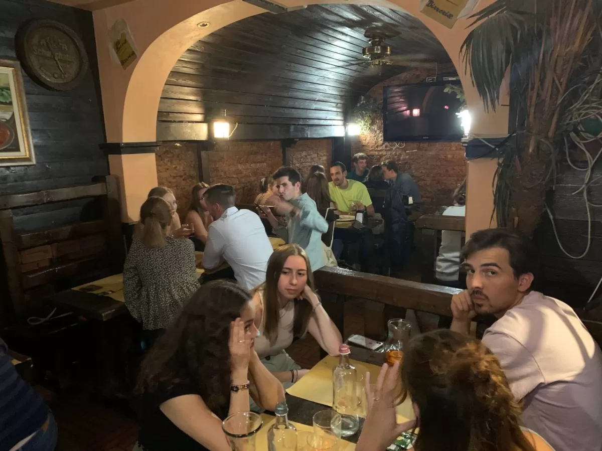 International students and ESN volunteers enjoying a typical local dinner