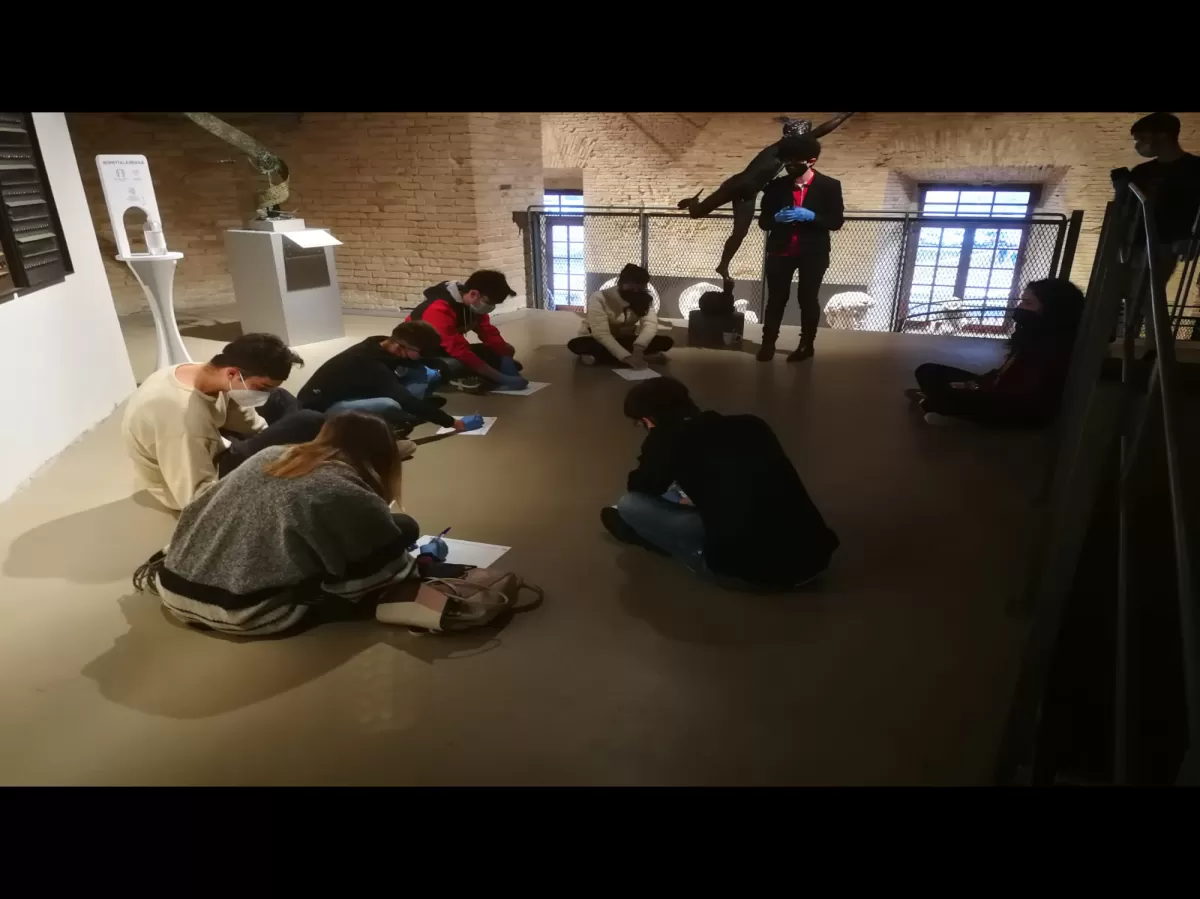 Group of international students sitting in circle and drawing