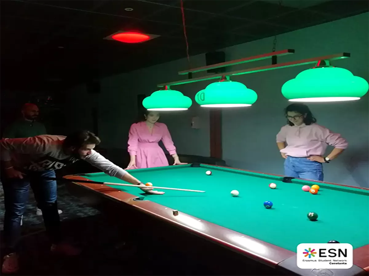 Group photo of students playing pool