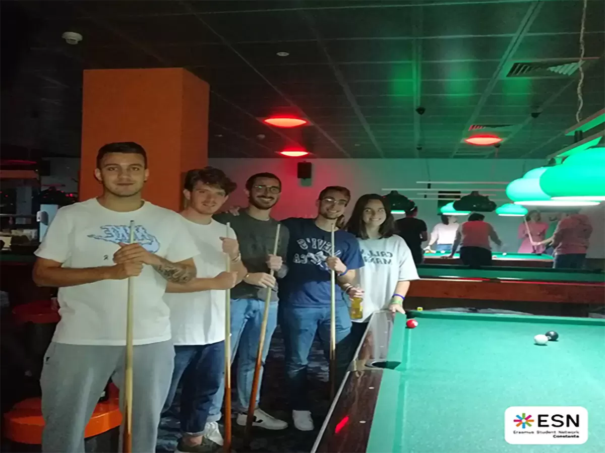 Group photo of students playing pool