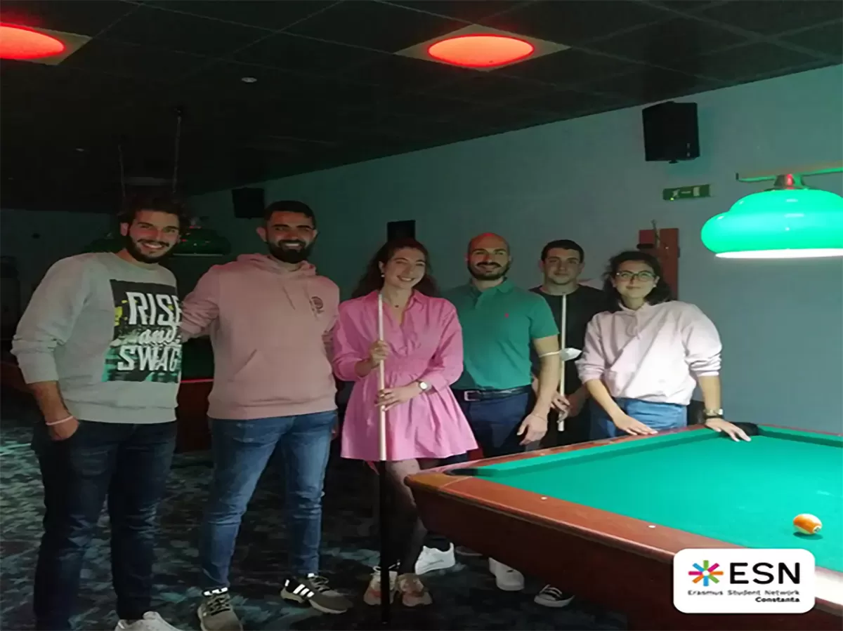 Group photo of students playing pool