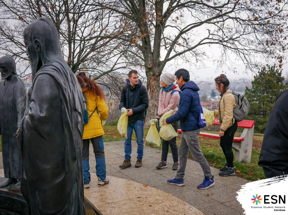 Students with trashbags hiking