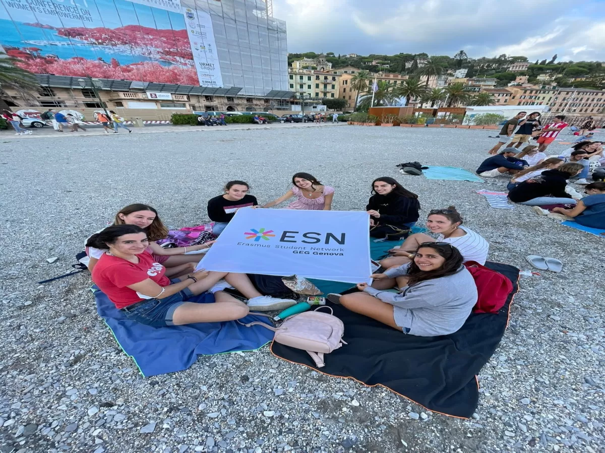 International students on the beach with ESN flag