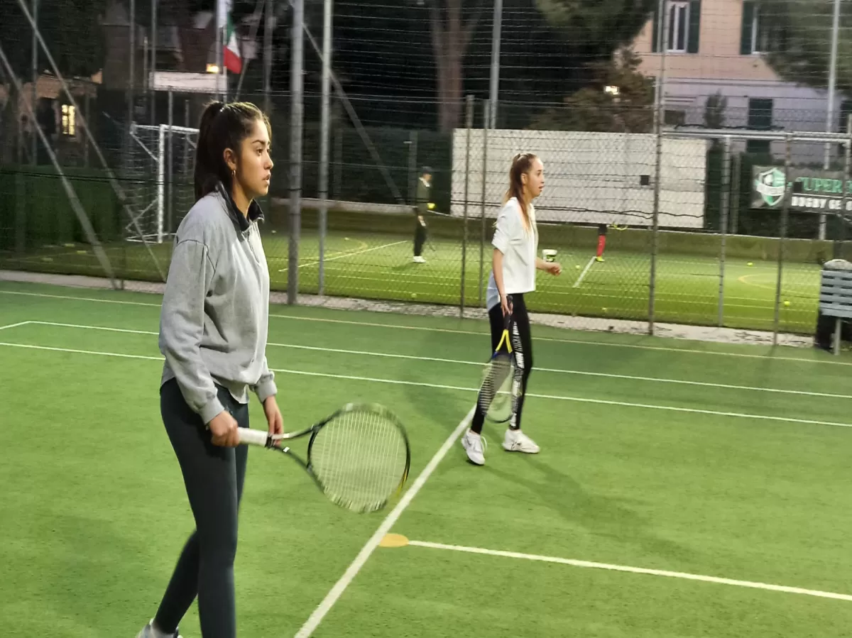 Two international students playing tennis