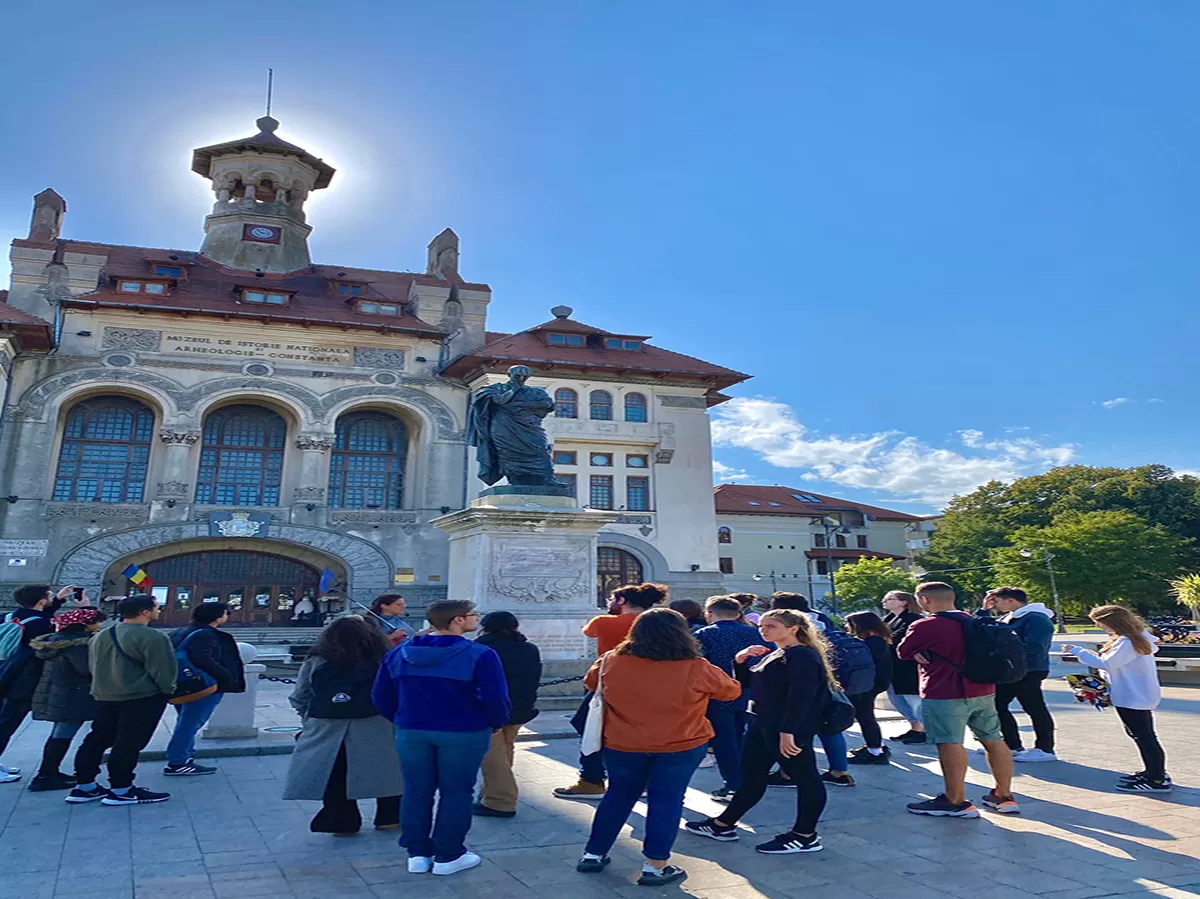 group photo of erasmus students in front of historical buildings
