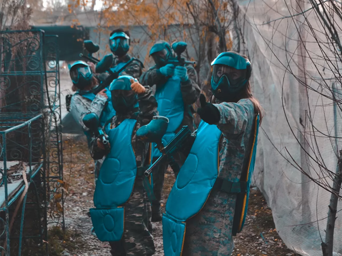 Participants are posing to camera with their paintball uniforms