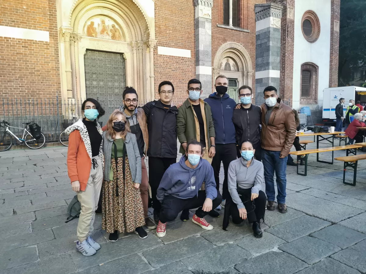 Group of international students and ESNers posing next to Sant'Eustorgio church