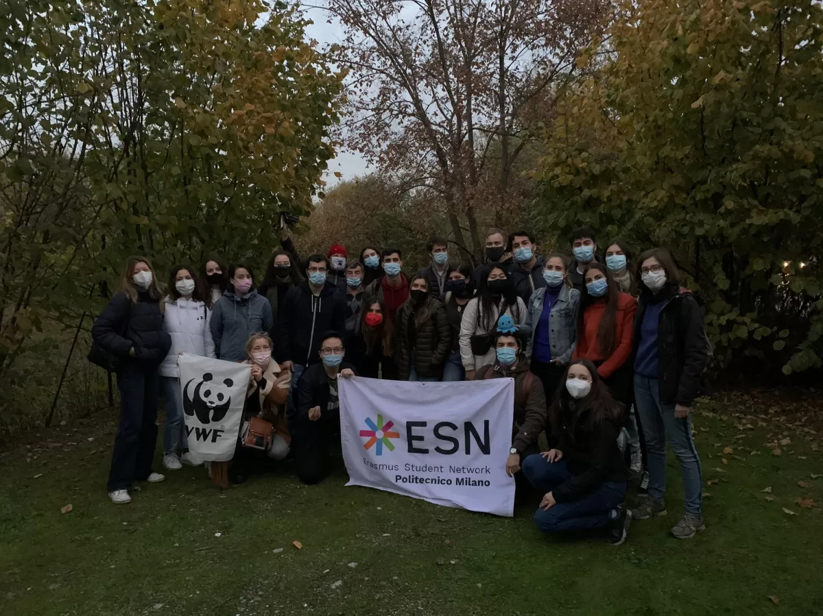 Group of international students and ESNers posing with the ESN flag inside the WWF oasis park