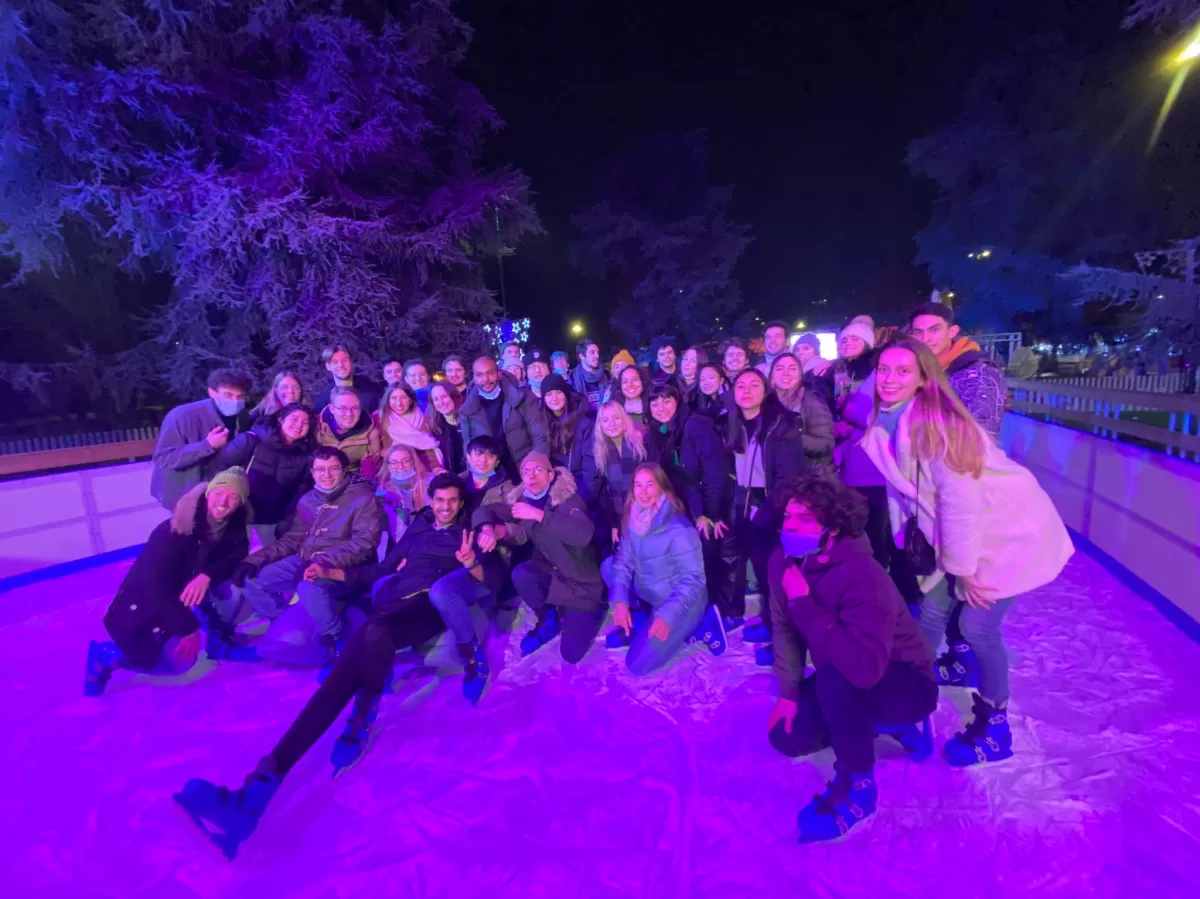 Group of international students and ESNers posing on the ice skating ring