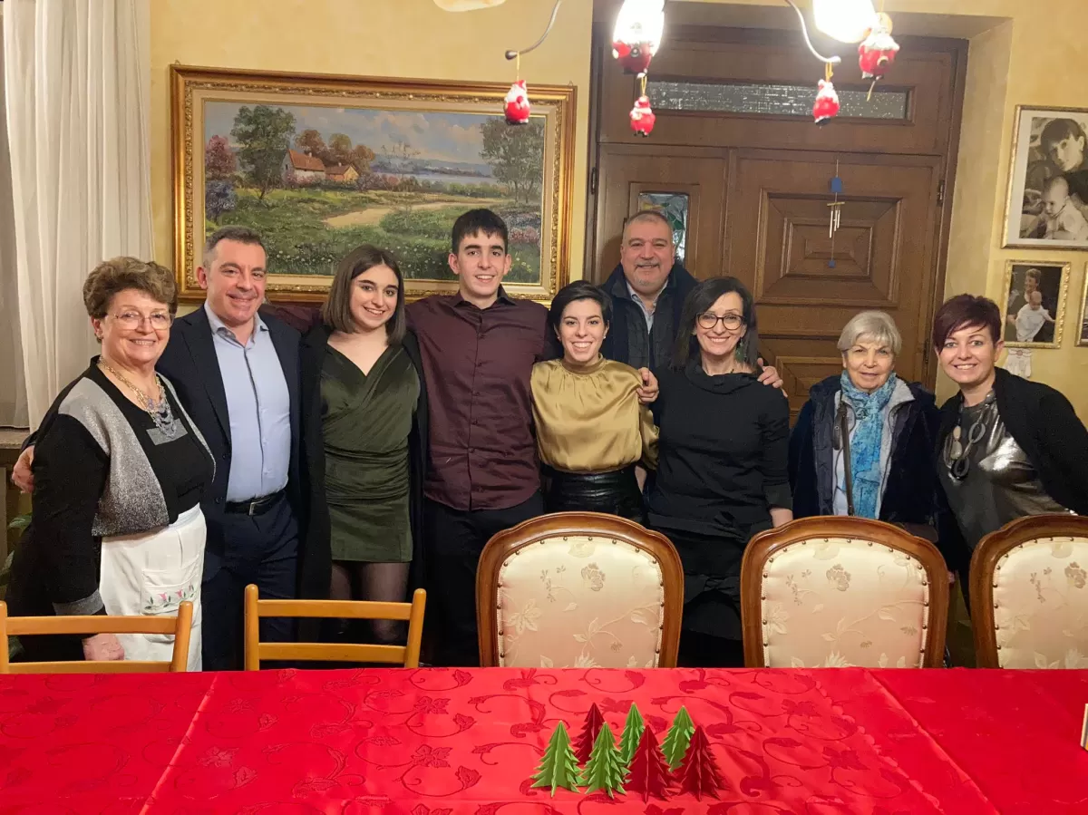 Italian family having Christmas dinner with an international student
