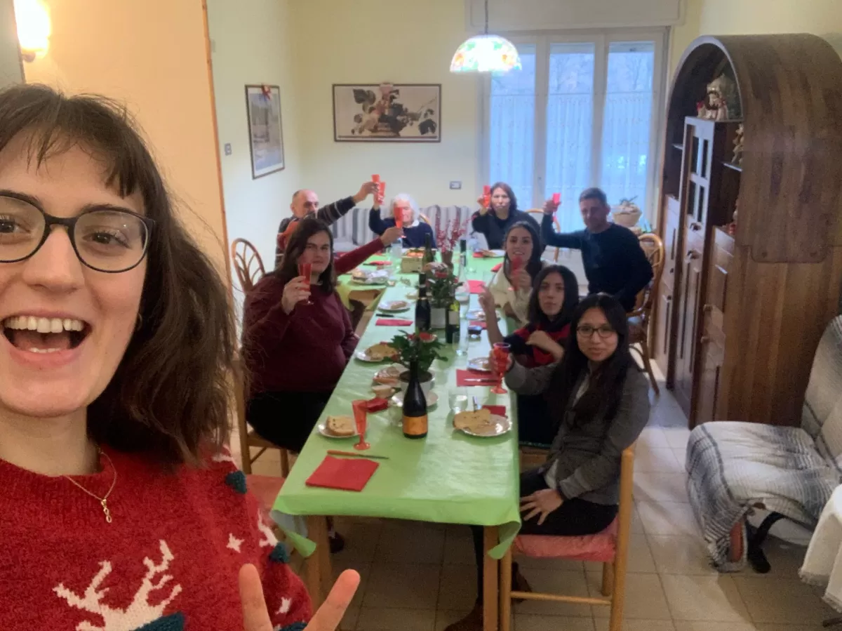 Italian family having Christmas dinner with an international student
