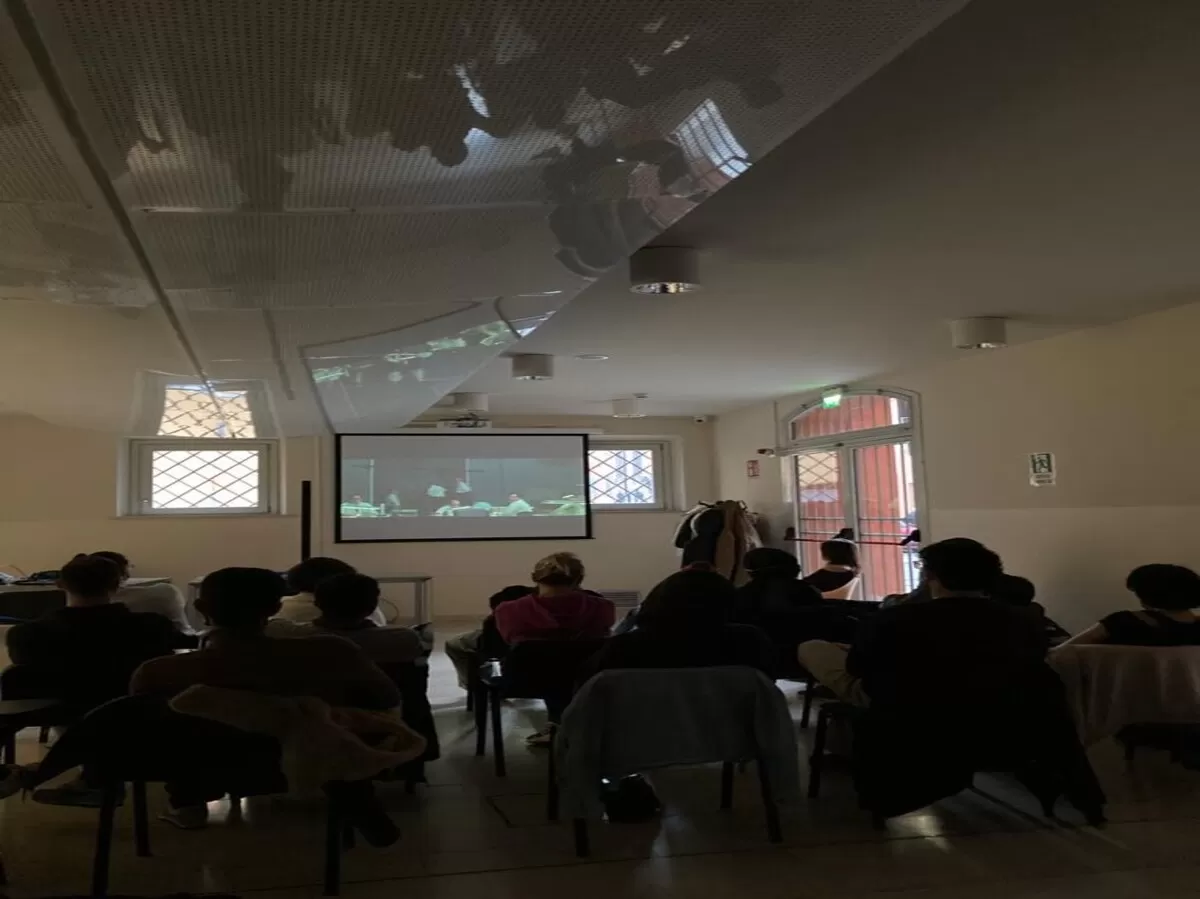 A group of international students watching a film for International Women's Day