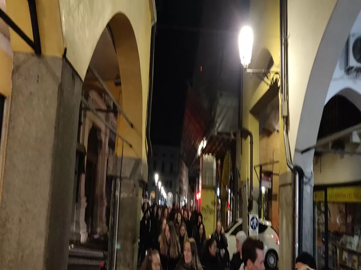 International students walking through Padova city center at night