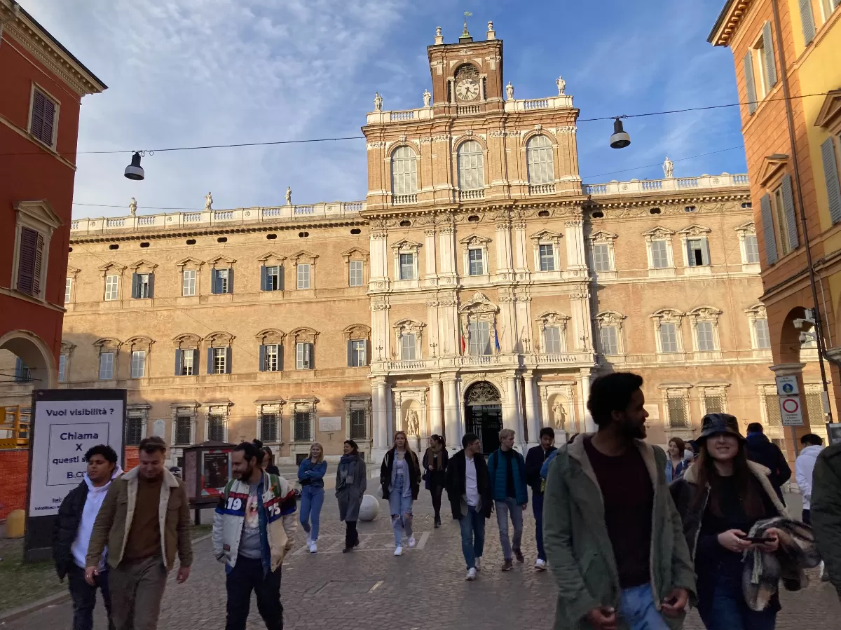 students walking in front of Palazzo Ducale of Modena