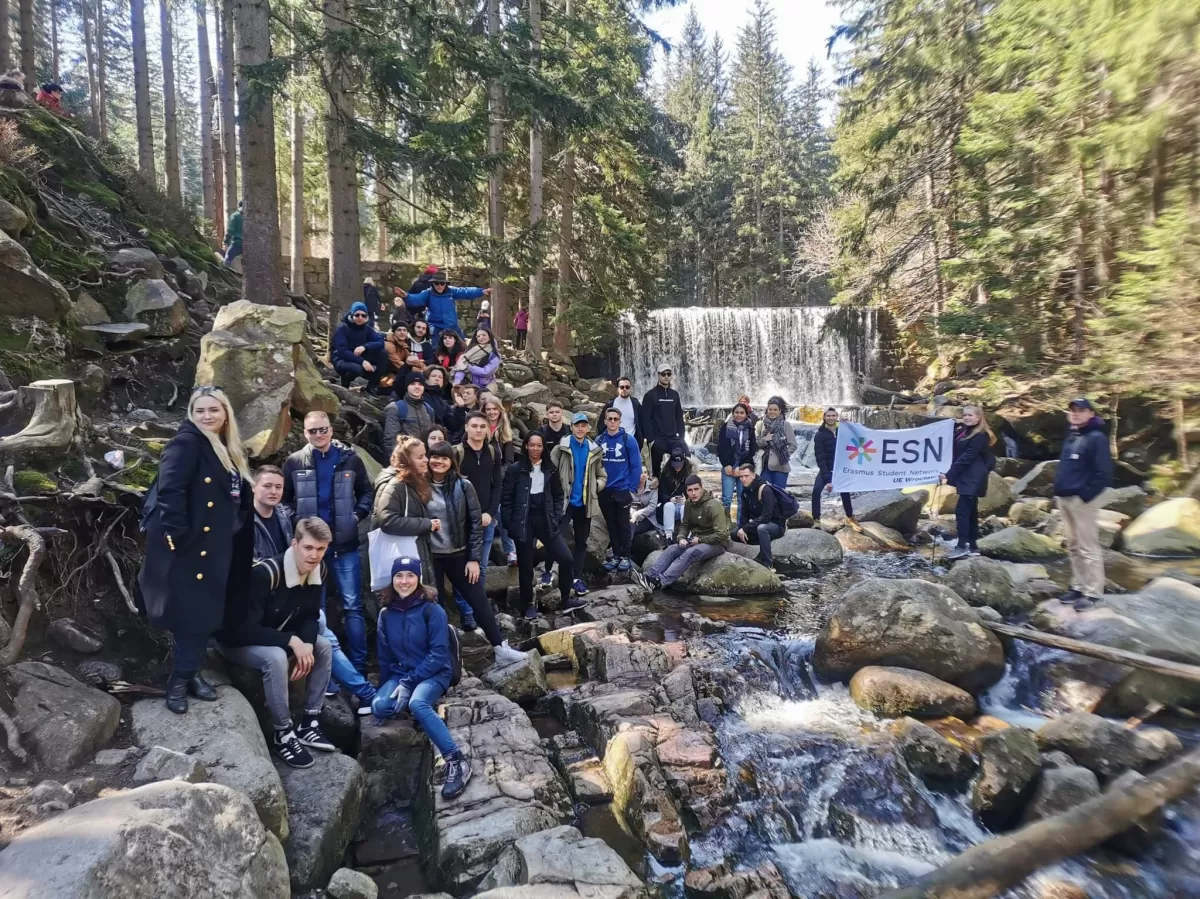 Group of erasmus students with waterfall