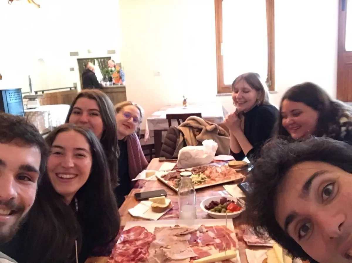 Erasmus students and staff members eating typical food in a typical restaurant called "osmiza" in Trieste