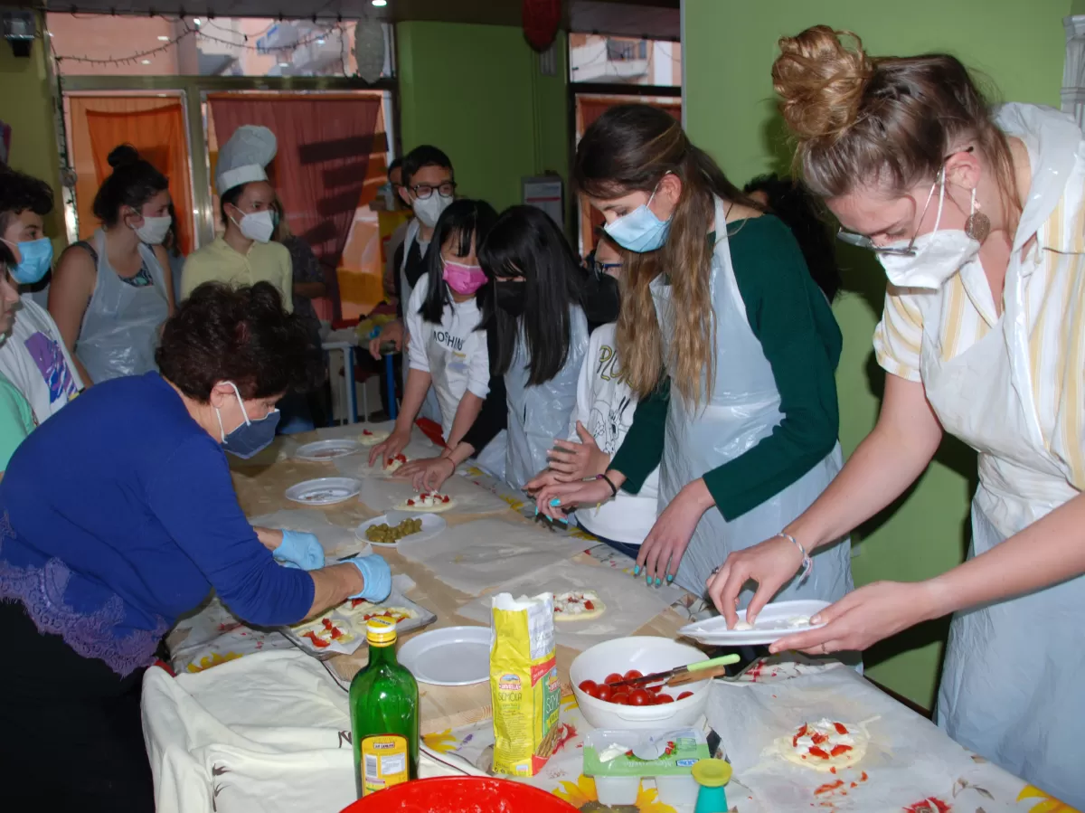 International students and pupils cooking together
