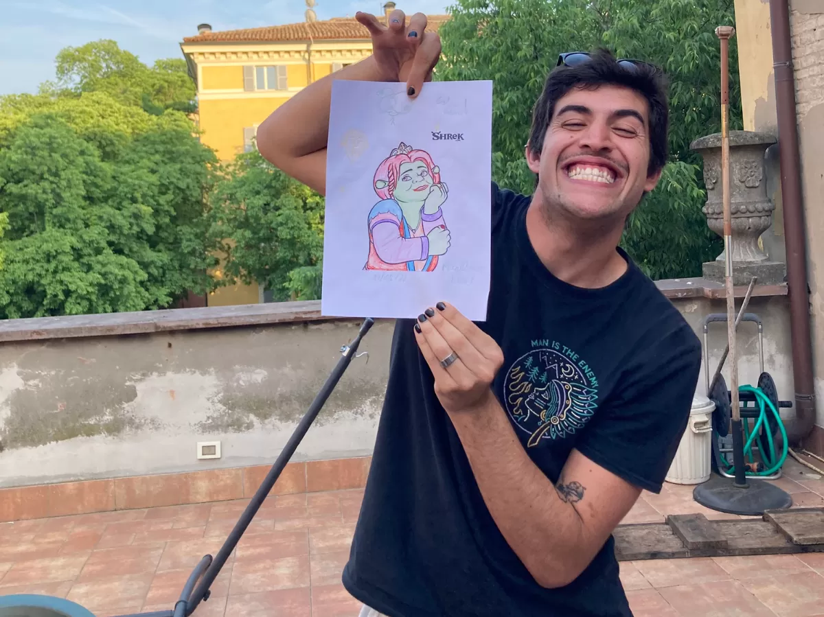 Another international student holding proudly his final drawing