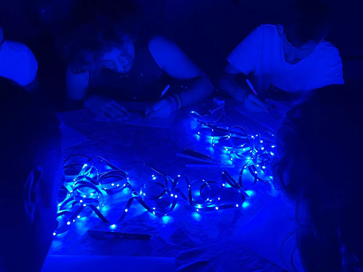 International students drawing with LED lights on