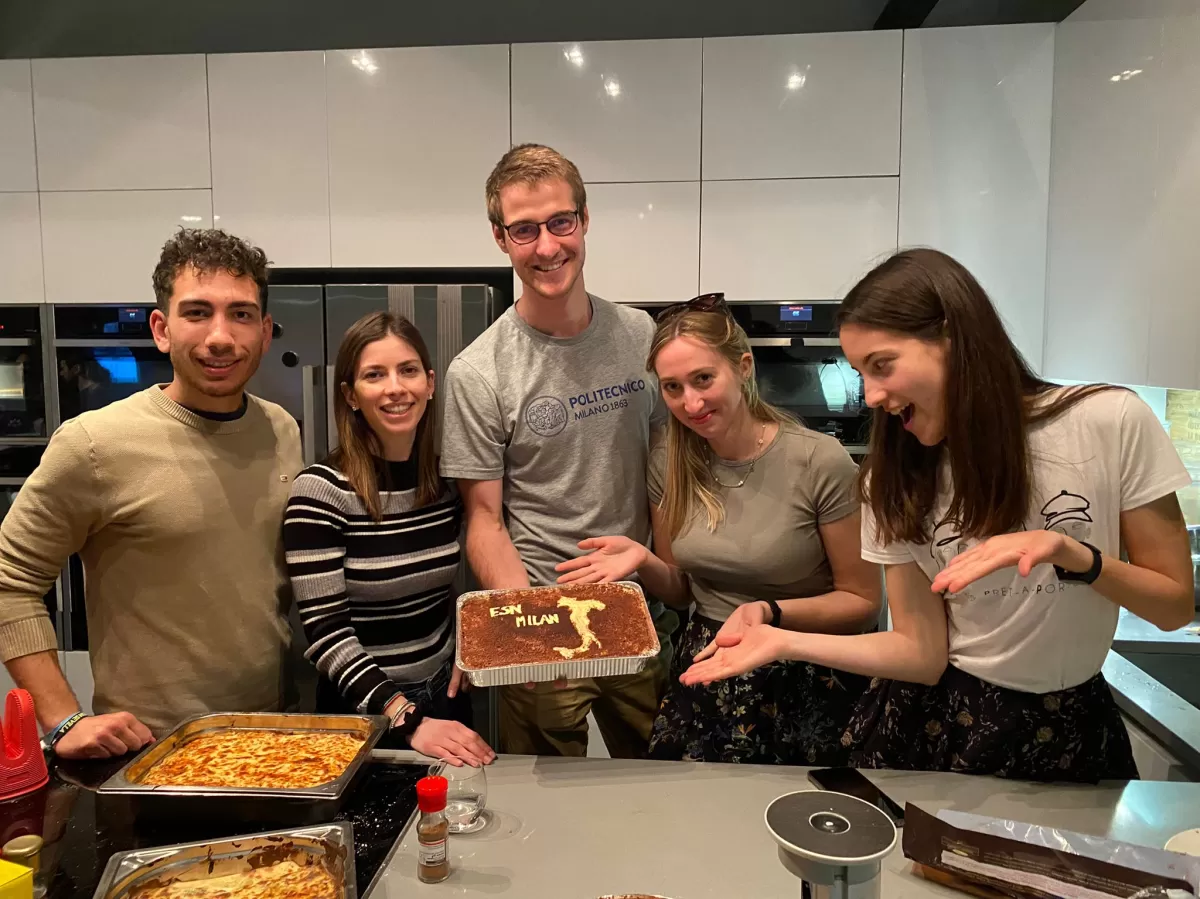 Group of international students showing the italian tiramisu that they have just cooked