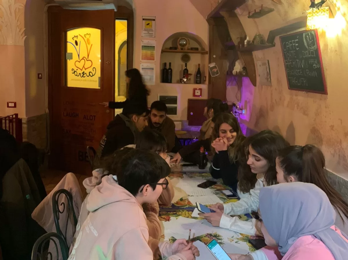 International students playing a game at one table