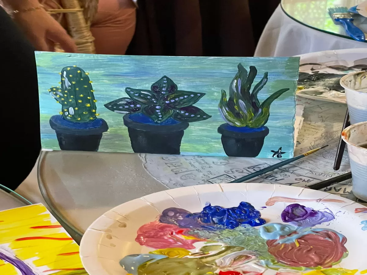 Cactus painting next to the paiting tools and materials