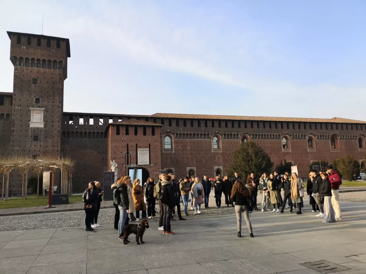 Group of international students listening to a ESN guide in front of Sforza castle