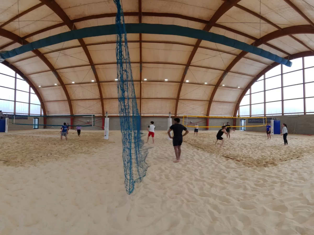 Group of international students playing beachvolley indoor