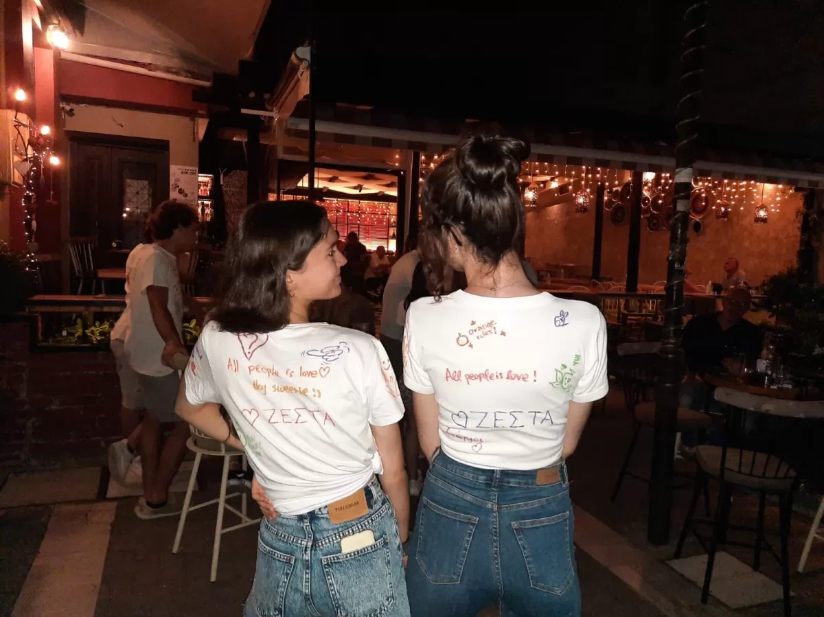 two local students showing us their painted white t-shirts