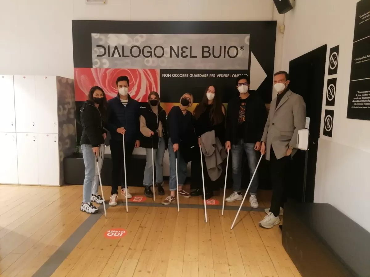 Group of international students posing with the white cane