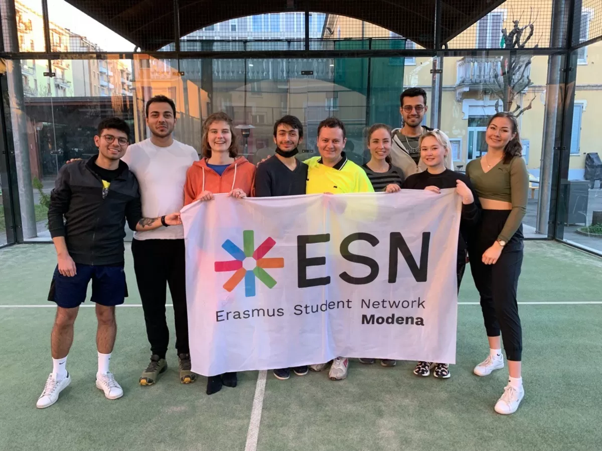 international students posing with the ESN Modena flag